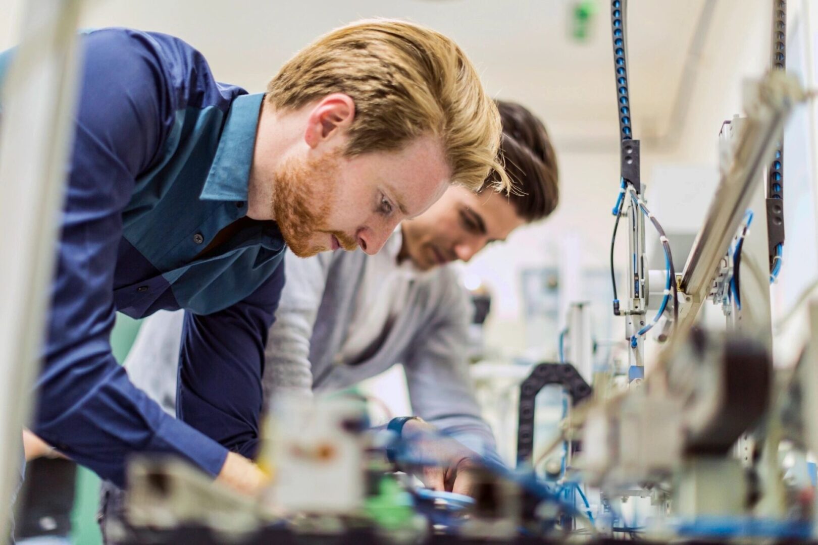 Two men working on a project in an industrial setting.