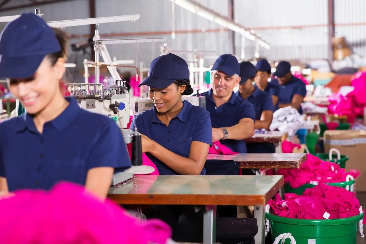 A group of people in blue shirts and hats.